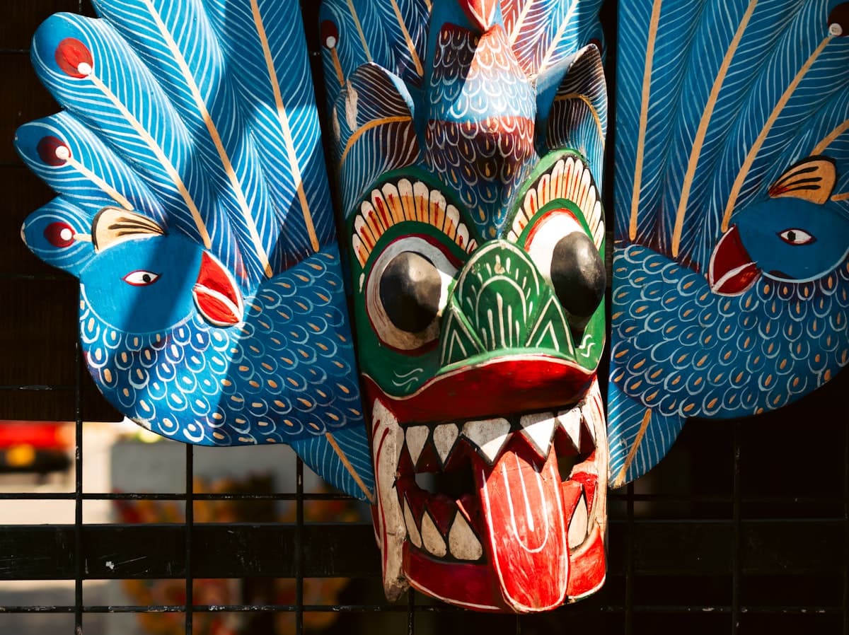 A vivid Sri Lankan Mayura Raksha mask hand-carved from wood in Ambalangoda