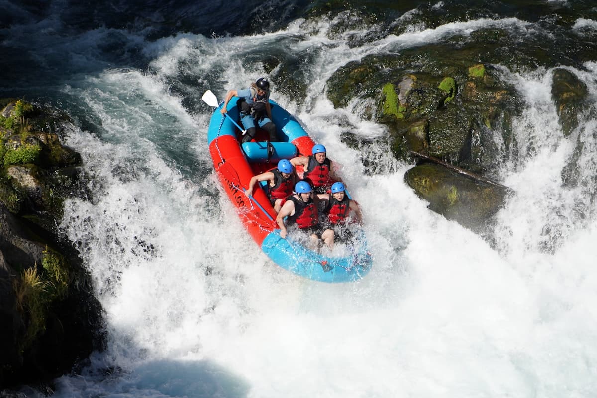 A whitewater rafting crew paddling the Kelani River rapids at Kitulgala, Sri Lanka